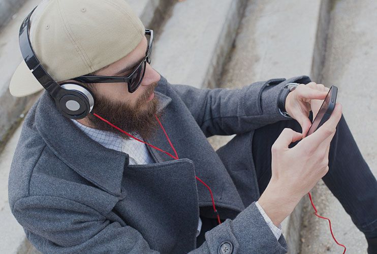 Man with headphones sitting on stairs